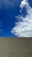 A blue sky with cloud after old wall photo