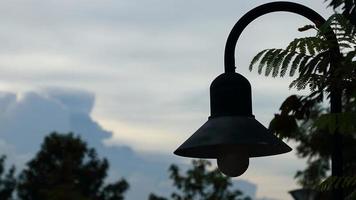 old black lamp on a sky background photo