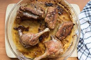 Duck meat baked in the oven with a crispy crust in an ovenproof dish photo
