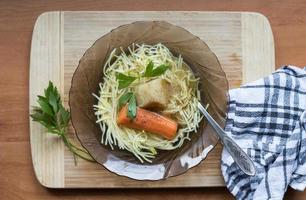 Polish chicken soup with noodles and parsley photo