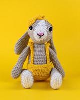 Knitted rabbit, handmade toy. photo