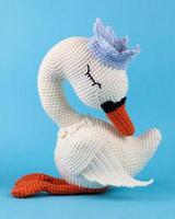 A knitted swan, a handmade toy. photo