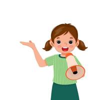 happy little girl holding megaphone speaking and shouting making announcement with hand showing for copy space vector