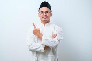 Asian muslim mas pointing something on his side with his both hand photo