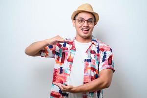 Asian man gesturing with hands showing big and large size sign, measure symbol. smiling looking at the camera. measuring concept. photo