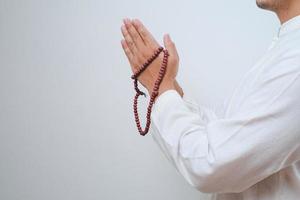 Close up Hand holding a tasbih or prayer beads photo