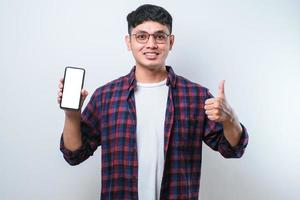 Asian Guy Smile looking to camera Showing Smartphone Empty Screen Recommending Application photo