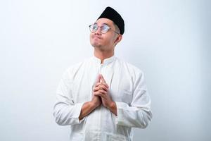 Asian muslim man doing thinking gestire, looking for idea photo