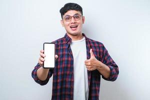 Asian Guy Smile looking to camera Showing Smartphone Empty Screen Recommending Application photo