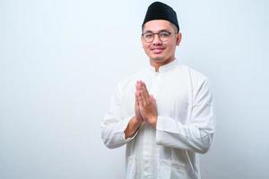 Asian Muslim man smiling to give greeting during Ramadan and Eid Al Fitr celebration photo