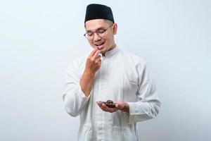Asian muslim man eating dates fruit photo
