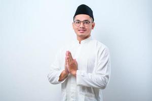 Asian Muslim man smiling to give greeting during Ramadan and Eid Al Fitr celebration photo