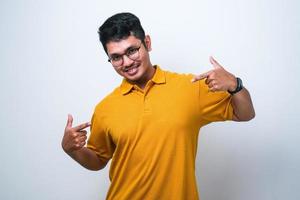 Young handsome man wearing casual shirt looking confident with smile on face, pointing oneself with fingers proud and happy photo