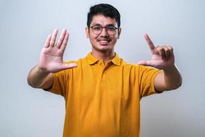Asian young man showing and pointing up with fingers number seven photo