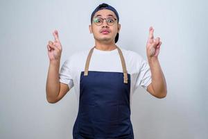 Asian young barista cross fingers for good luck, make a wish photo