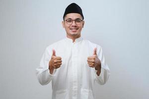 asian muslim male wearing glasses smile look to camera showing thumbs up photo