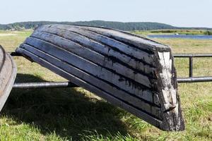 wooden boats are dried on the shore photo