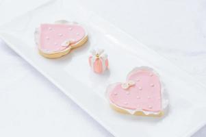 many pink cookies on a white plate photo