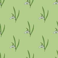 Seamless pattern with positive snowdrops on light green background. Vector image.