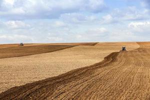 tractor plowing the fields photo