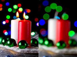 Red and white candle with a green New Year's ball on the background of lights photo