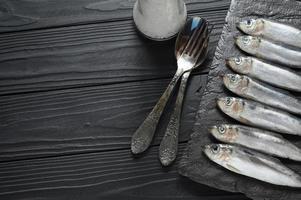 Fresh herring on rustic wooden background, close up shot photo