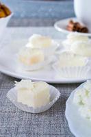 Chocolates in heart shaped white chocolate on the tablecloth photo