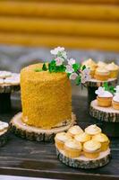 tortas en una mesa de madera para una barra de dulces de boda foto