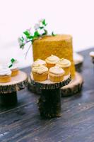 tortas en una mesa de madera para una barra de dulces de boda foto