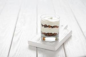 Greek yogurt with granola in glass jar. Parfait photo