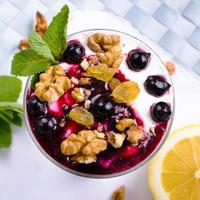 cream dessert with black currants and nuts photo