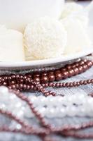 heart-shaped chocolates with candies in coconut flakes of beads photo