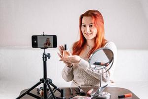 Woman beauty blogger records video content on her smartphone for your vlog. Modern influencer photo