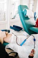 International Blood Donation Day. Man donates blood in medical laboratory. photo