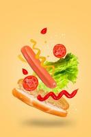 Levitating hot dog on yellow background. Flying hotdog ingredients. photo