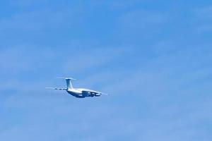 Airplane in blue sky. Air cargo transportation. Plane is flying photo