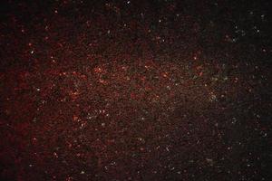 Space abstract background. Christmas backdrop. Texture of red shiny crystals. photo