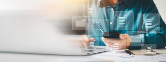 Document management system concept, business man holding folder and document icon software, searching and managing files online document database, for efficient archiving and company data. photo