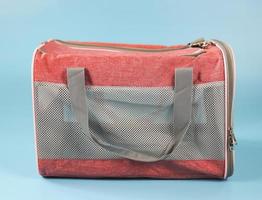 Animal transportation bag, isolated on blue background. photo