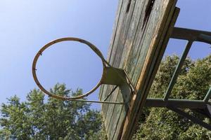 an old basketball ring in the yard photo