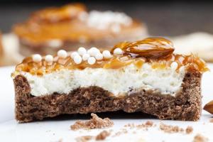 tartlet with milk cheese filling and lots of salted caramel with nuts photo