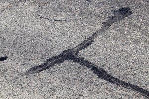 part of an asphalt road with damage photo