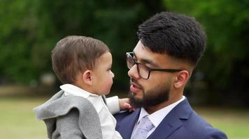 Asian Pakistani Father is holding his 11 Months Old Infant at Local Park video