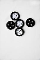 Large black and white buttons with clothes on a white background photo