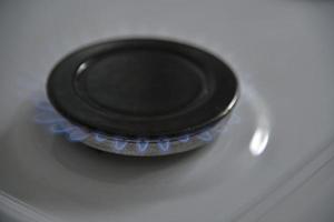 A burning gas burner on the kitchen stove photo