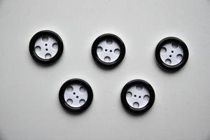 Large black and white buttons with clothes on a white background photo