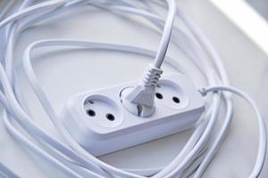 White electric extension cord, great design for any purposes. White background. photo
