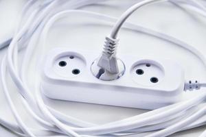 White electric extension cord, great design for any purposes. White background. photo