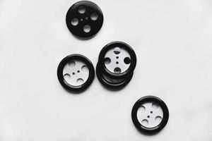 Large black and white buttons with clothes on a white background photo