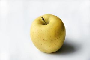Yellow sweet apple on a white background photo
